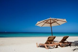 Chairs on tropical beach under umbrella